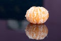 Peeled tangerine on a black background