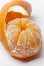 Peeled tangerine with a curly skin Royalty Free Stock Photo