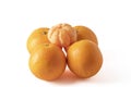 Peeled tangerine on four oranges isolated on white background Royalty Free Stock Photo