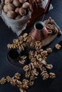Peeled walnuts on a dark background. Coffee in a copper turk. The kernel of a walnut. Wooden board. A natural product. Vertical