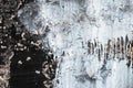 Peeling background. Gray grunge texture. Cement cracked wall. Rough structure. Dripping paint. Old black flaky facade Royalty Free Stock Photo