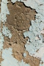 Peeling blue paint on plaster.