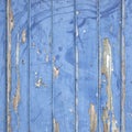 Peeling blue paint on wooden door or fence