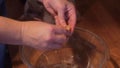 Peeling boiled, butterflied shrimp over a glass bowl