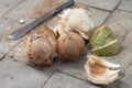 Peeling coconut using a knife.