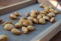 Peeling fresh almonds on an outdoor table in a sunny summer day. Home grown bio  food, farm life, country life Royalty Free Stock Photo