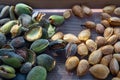 Peeling fresh almonds on an outdoor table in a sunny summer day. Home grown bio  food, farm life, country life Royalty Free Stock Photo