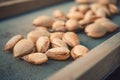 Peeling fresh almonds on an outdoor table in a sunny summer day. Home grown bio  food, farm life, country life Royalty Free Stock Photo