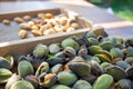 Peeling fresh almonds on an outdoor table in a sunny summer day. Home grown bio  food, farm life, country life Royalty Free Stock Photo