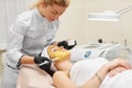 Cosmetologist doing beauty procedure for patient.