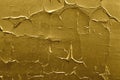 Peeling paint of golden color on concrete wall. Gold weathered textured flaked graffiti background Royalty Free Stock Photo