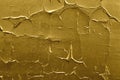 Peeling paint of golden color on concrete wall. Gold weathered textured flaked graffiti background