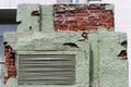 Peeling green plaster on a brick transformer box. background for the image of devastation and mismanagement. Russia