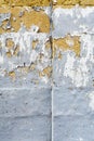 Peeling grey paint on limestone brick