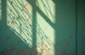 Peeling mint green wall texture with shadows of barred window creating abstract patterns. Aged, weathered surface with visible Royalty Free Stock Photo