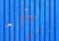 Peeling paint on blue aluminium wall pattern