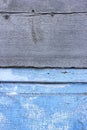 Peeling paint on the old door in the snow. A pattern of rustic blue grunge material. Abstract background. Royalty Free Stock Photo