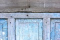 Peeling paint on the old door in the snow. A pattern of rustic blue grunge material. Abstract background. Royalty Free Stock Photo