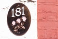House number 181 on an oval plaque with three roses Royalty Free Stock Photo