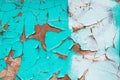 Peeling turquoise paint on a concrete wall. Blue and white painted abstract backgrounds, cracked rusty metal surface, faded Royalty Free Stock Photo