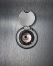 Peep hole closeup with human eye