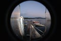 Peephole view of a small port with boats in the water