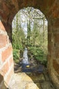 Peeping through a brick archway into view of the countryside