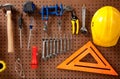 Peg board with tools and hard hat Royalty Free Stock Photo