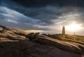 Peggy`s Cove Lighthouse at sunset with storm clouds Royalty Free Stock Photo