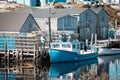 Peggy's Cove harbor - fishing boat and storage houses