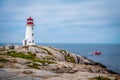 Peggy's Cove Lighthouse with red fisherman boat, Nova Scotia, Canada Royalty Free Stock Photo