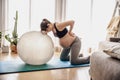 Pegnant woman doing exercise at home