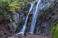 Pfeiffer Falls Waterfall. Cascade down stone cliff with green vegetation Branches, sand below. Royalty Free Stock Photo