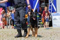 German police dog handler with a police sheepdog