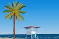 Peisage of seashore with palms and lifeguard hut. Blue clear sky Royalty Free Stock Photo