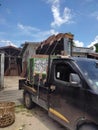 Pekanbaru - Indonesia, January 22, 2023; pickup truck loaded with furniture, large glass cupboard.