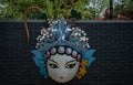 peking opera mask on brick wall background Royalty Free Stock Photo