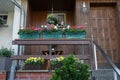 Pelargoniums, pansies and daisies in flower boxes and pots decorate the porch of the house. Berlin, Germany