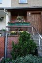 Pelargoniums, pansies and daisies in flower boxes and pots decorate the porch of the house. Berlin, Germany Royalty Free Stock Photo