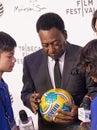 Pele Autographing a Soccer Ball in New York City 