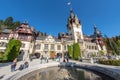 Peles Castle in Romania: fountain and tourists Royalty Free Stock Photo
