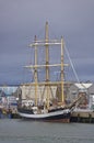 The Pelican of London a Class A Tall Ship alongside the quay at the Port of Montrose in Angus, under dark clouds. Royalty Free Stock Photo