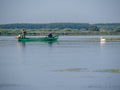 Pelican waiting for food from fishermen on Isac lake, Danube Delta, Romania Royalty Free Stock Photo