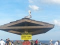 Pelican watching fishermen in sunny day