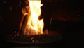 Pellets fire burn with spruce sawdust into the delivery strew bio wooden pallets to industrial modern boiler, sparks fly