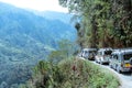 Tourist vehicles lined up to climb in the step hill region of himalayan mountain valley