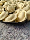 Pelmeni. Raw semi-finished dumplings on a marble table.  Close-up Royalty Free Stock Photo