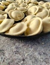 Pelmeni. Raw semi-finished dumplings on a marble table.  Close-up Royalty Free Stock Photo