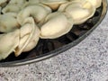 Pelmeni. Raw semi-finished dumplings on a marble table.  Close-up Royalty Free Stock Photo