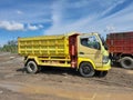 Pemalang, Central Java, Indonesia April 12, 2023. Photo of a yellow dump truck in a sand quarry in Indonesia